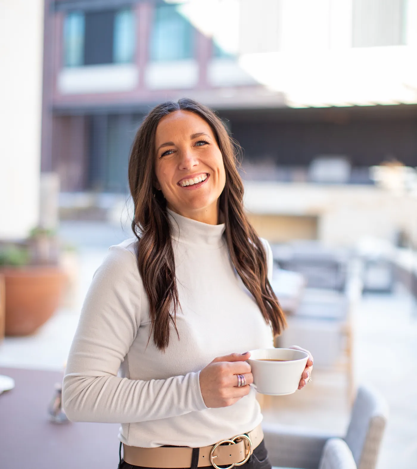 Mallory Robinson holding a cup of coffee